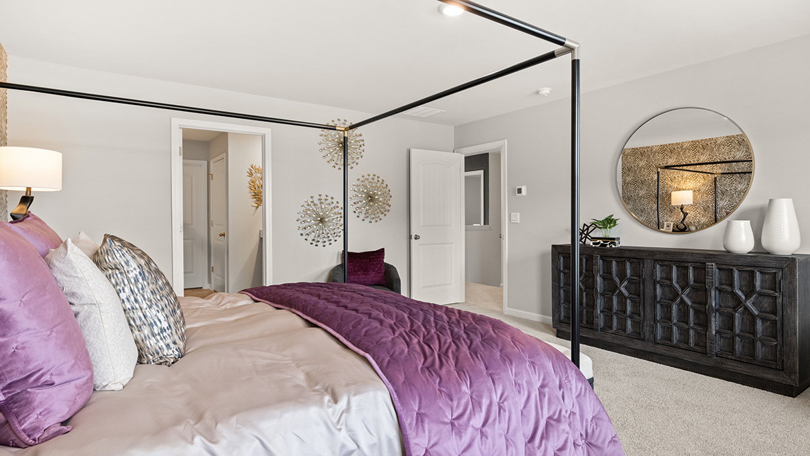 The master bedroom has a view of the master bath and an entrance from the hallway.