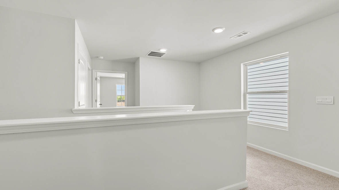 Interior upstairs loft area open to staircase