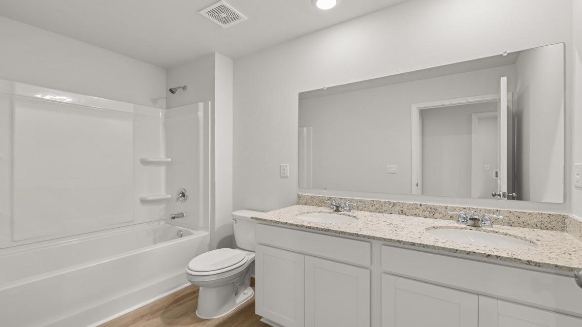 Interior bathroom with double sink and full sized shower