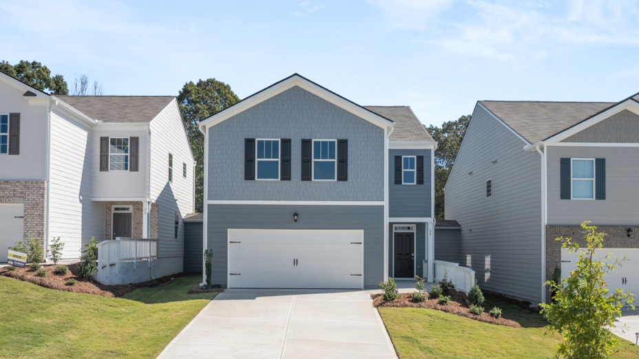 Two-story exterior home with tan and brown bricks, off-white siding, dark gray shutters, a porch, and a two-car garage.