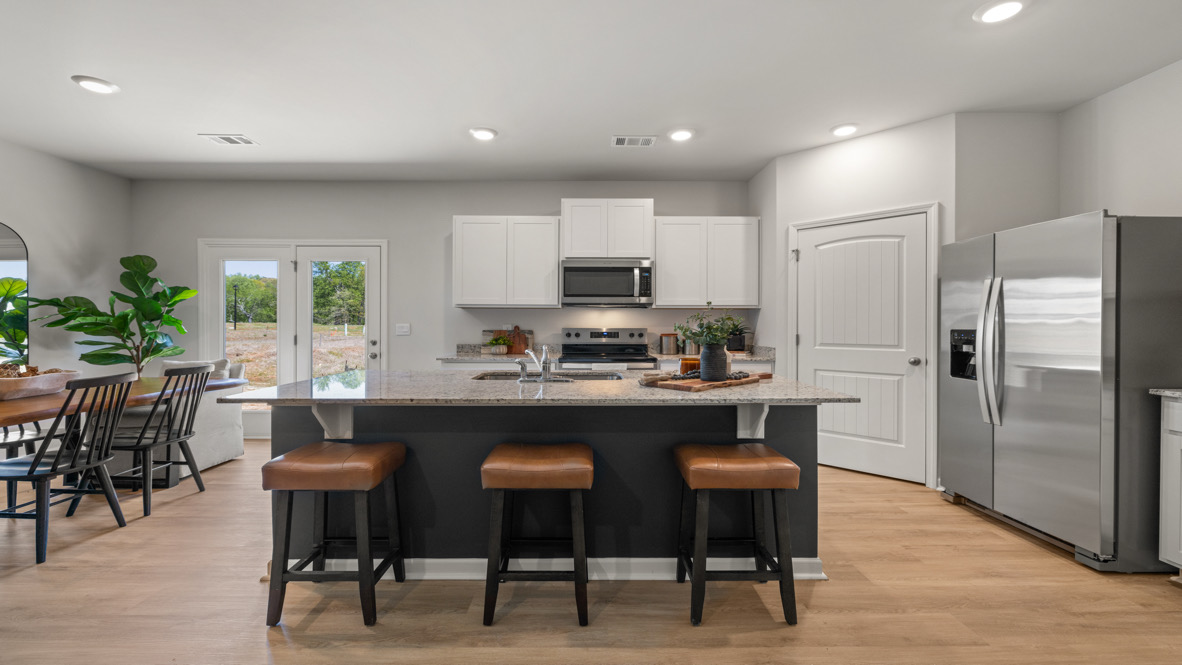 Interior kitchen with center island and white cabinets