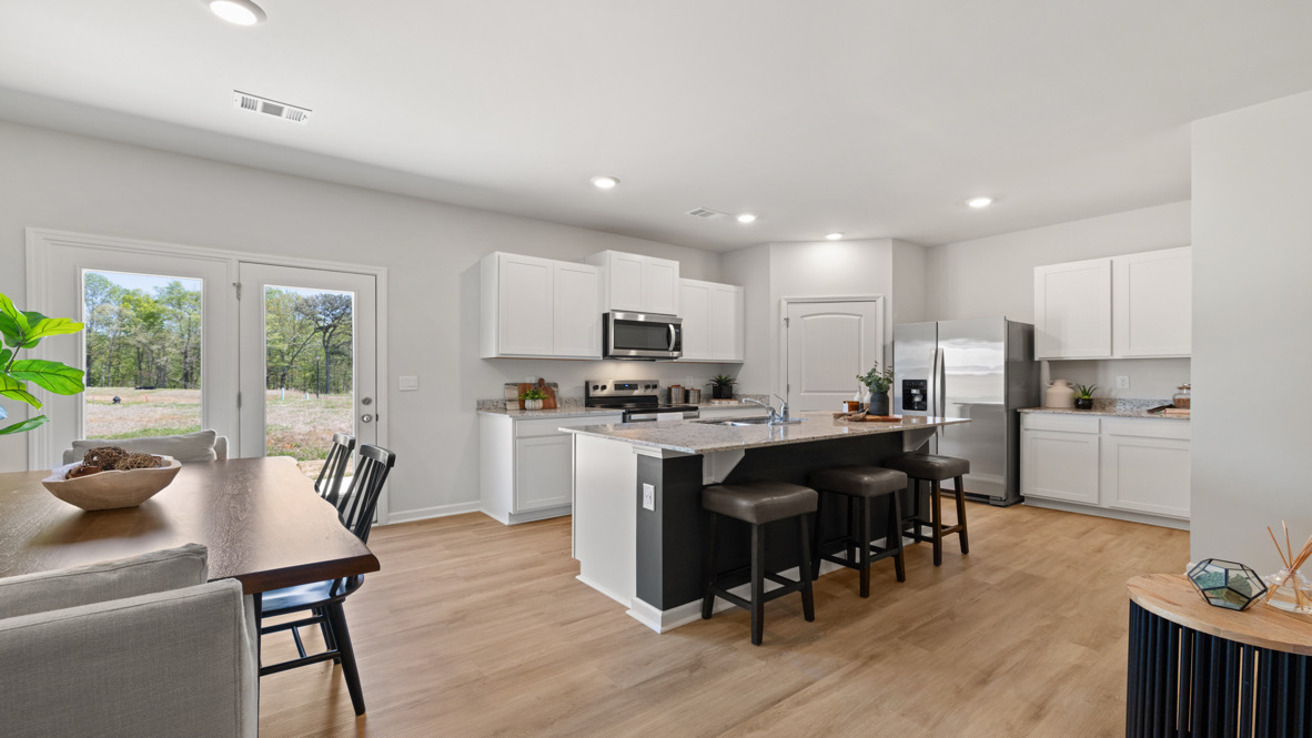 Interior kitchen with center island and white cabinets