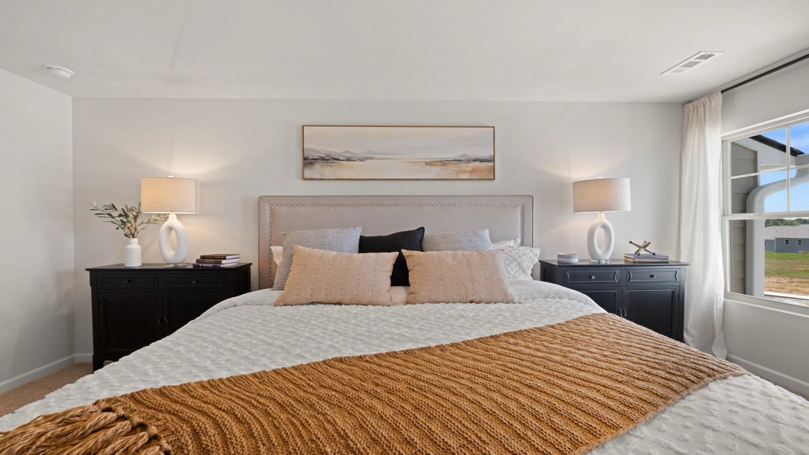 Interior primary bedroom with large windows