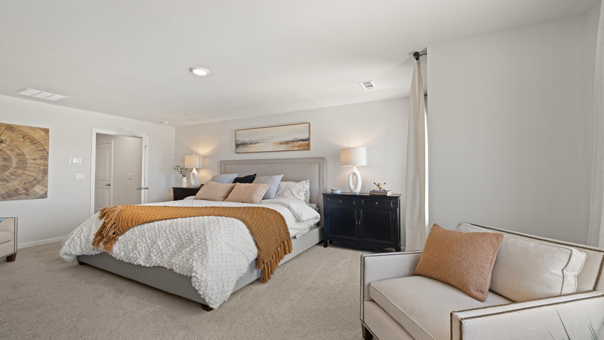 Interior primary bedroom with large windows