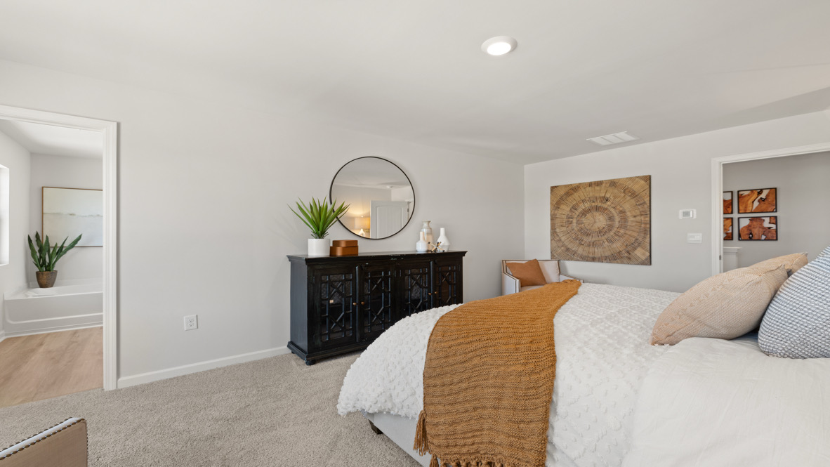 Interior primary bedroom with large windows