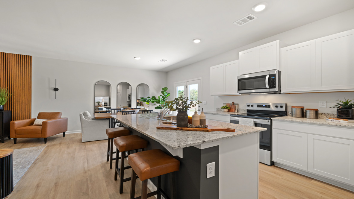 Interior kitchen with center island and white cabinets