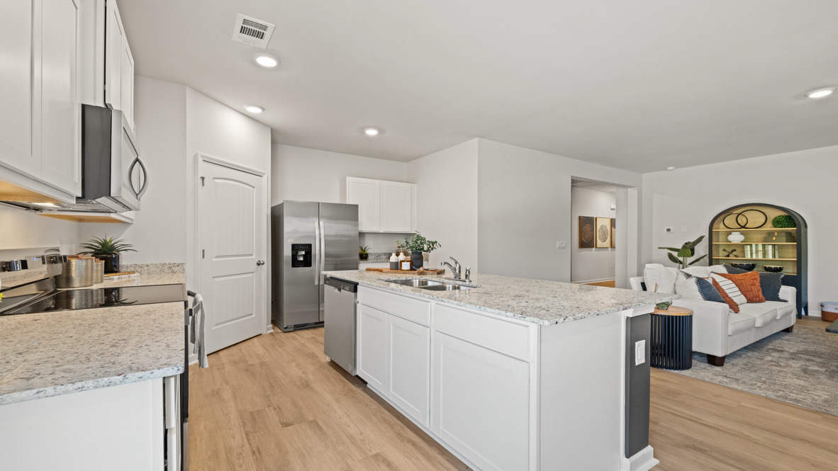 Interior kitchen with center island and white cabinets