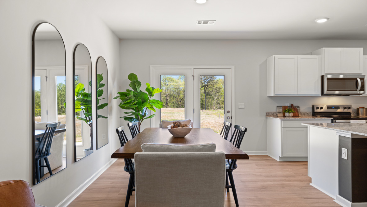 Interior dining area next to back patio doors and kitchen