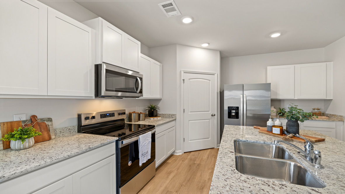 Open kitchen concept in Sudbury Plan with sleek finishes and ample storage in Rolling Meadows Jasper Georgia