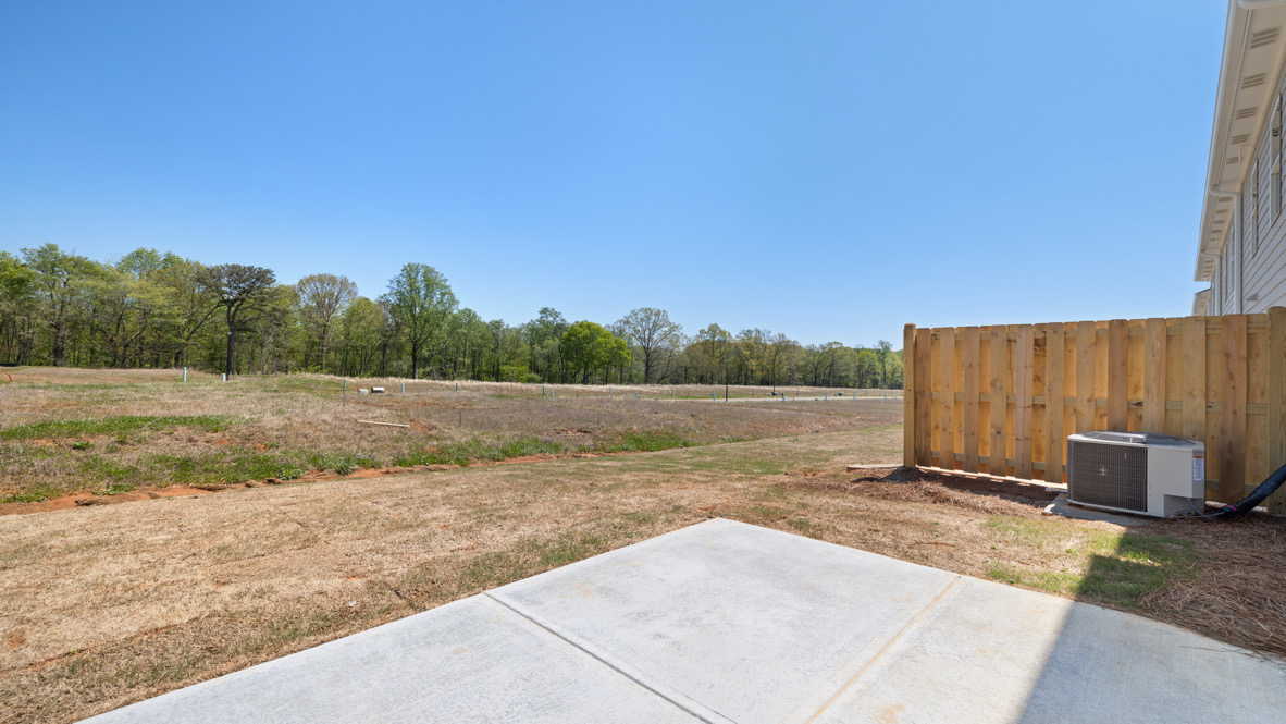 Functional backyard design with rear patio in D.R. Horton New Build Home located in a planned community Rolling Meadows