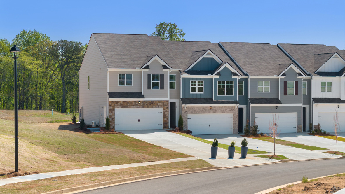 Front exterior of Sudbury Plan townhomes By D.R. Horton, by D.R. Horton in Rolling Meadows Jasper Georgia with modern curb appeal
