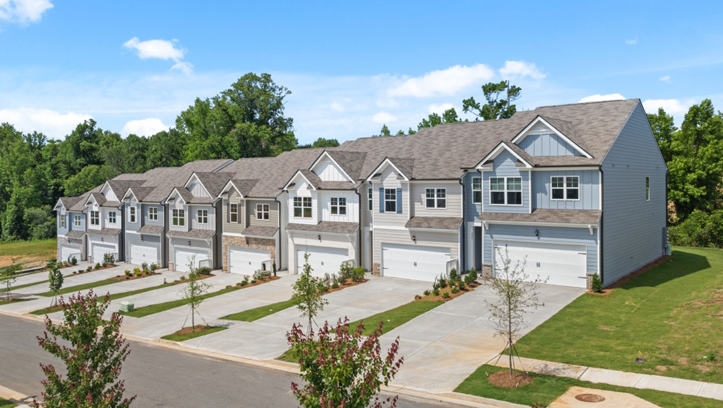 Front exterior of Sudbury Plan townhomes By D.R. Horton, by D.R. Horton in Rolling Meadows Jasper Georgia with modern curb appeal