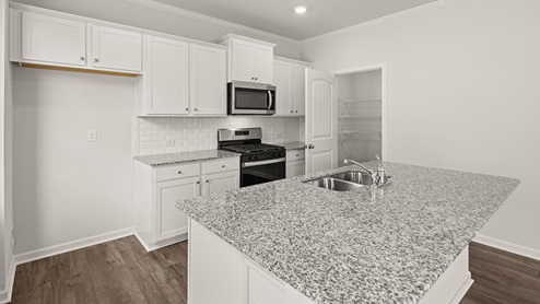 sample Penwell kitchen with white cabinets and granite countertops at palisades in dallas georgia