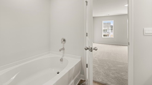 sample Penwell primary bathroom with separate tub and shower at palisades in dallas georgia