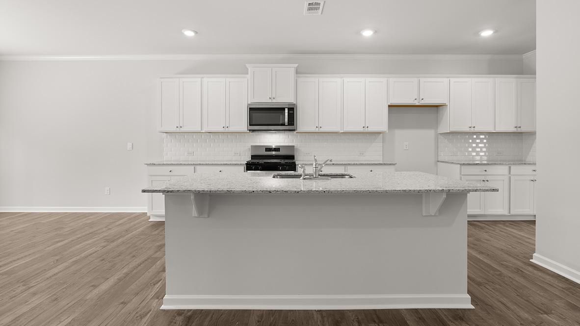 Interior kitchen with center island and white cabinets