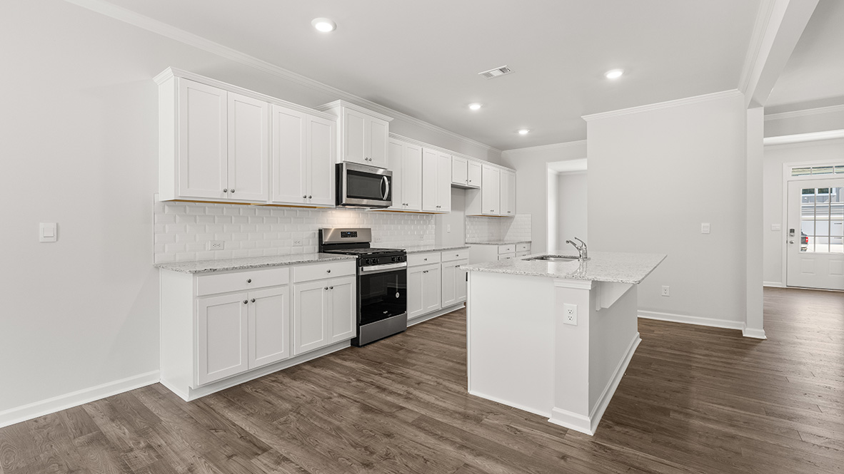 Interior kitchen with center island and white cabinets