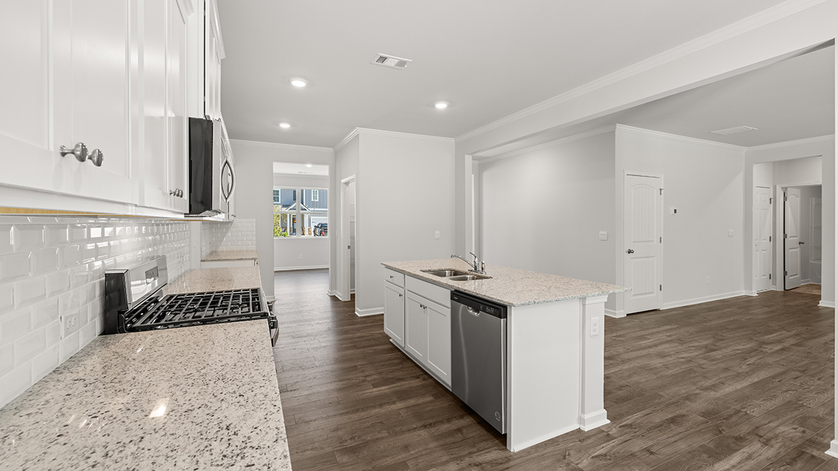 Interior kitchen with center island and white cabinets