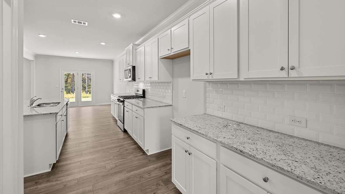 Interior kitchen with center island and white cabinets