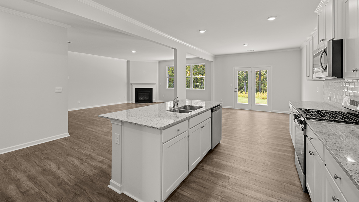 Interior kitchen with center island and white cabinets