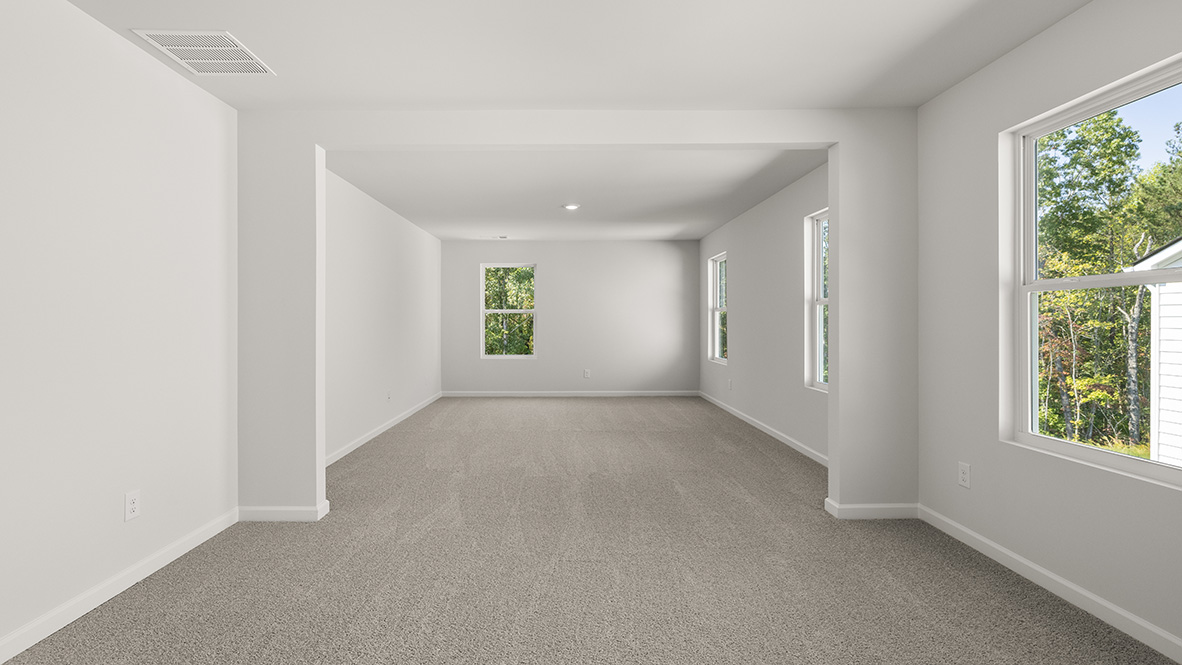 Interior primary bedroom with large windows