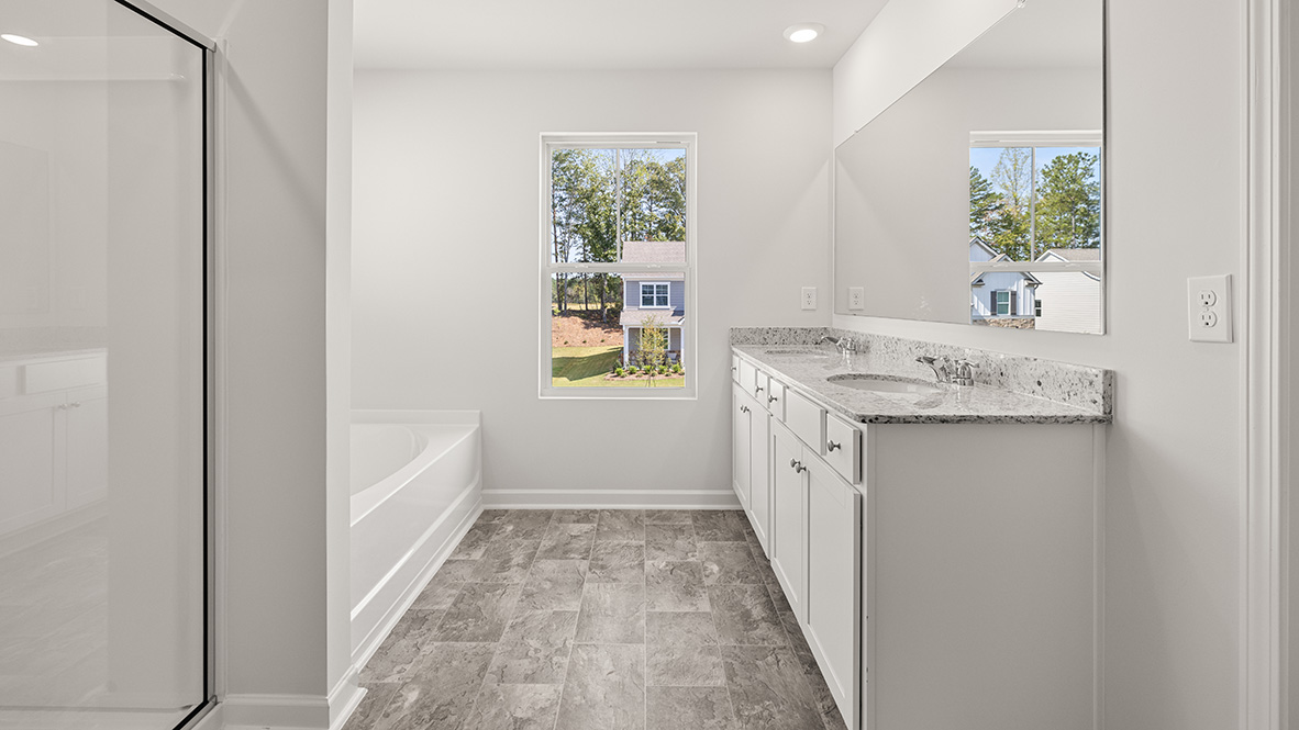 Interior primary bathroom with shower, bath tub and double sink