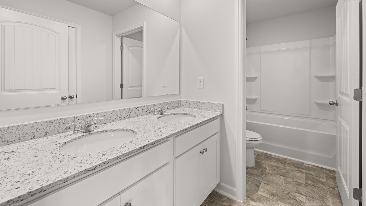 Interior bathroom with double sink and full-sized shower
