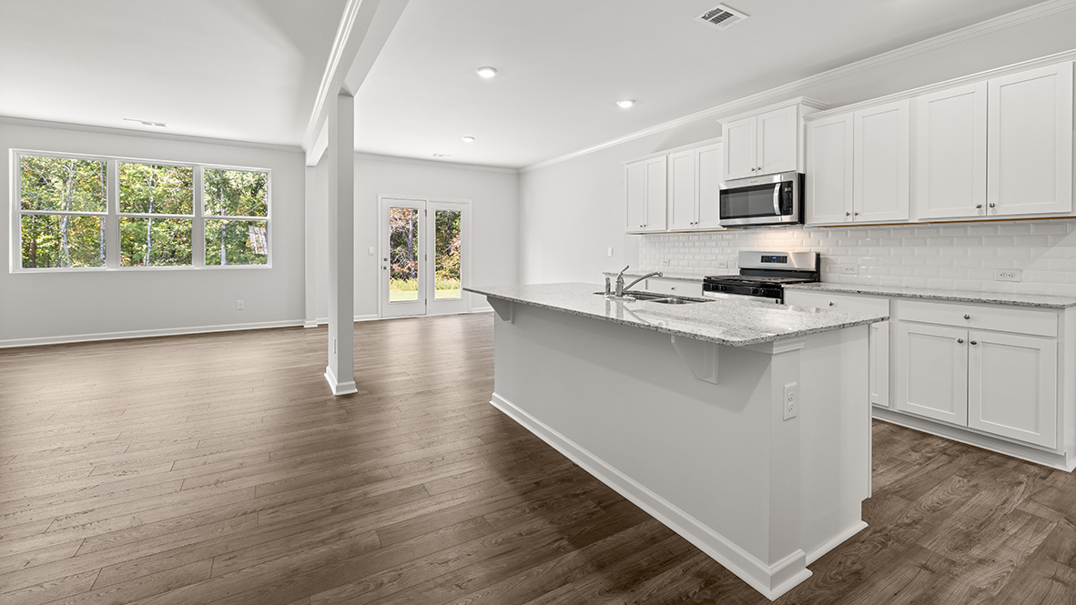 Interior kitchen with center island and white cabinets