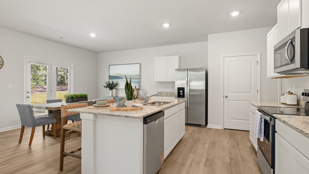 Interior kitchen with center island and white cabinets