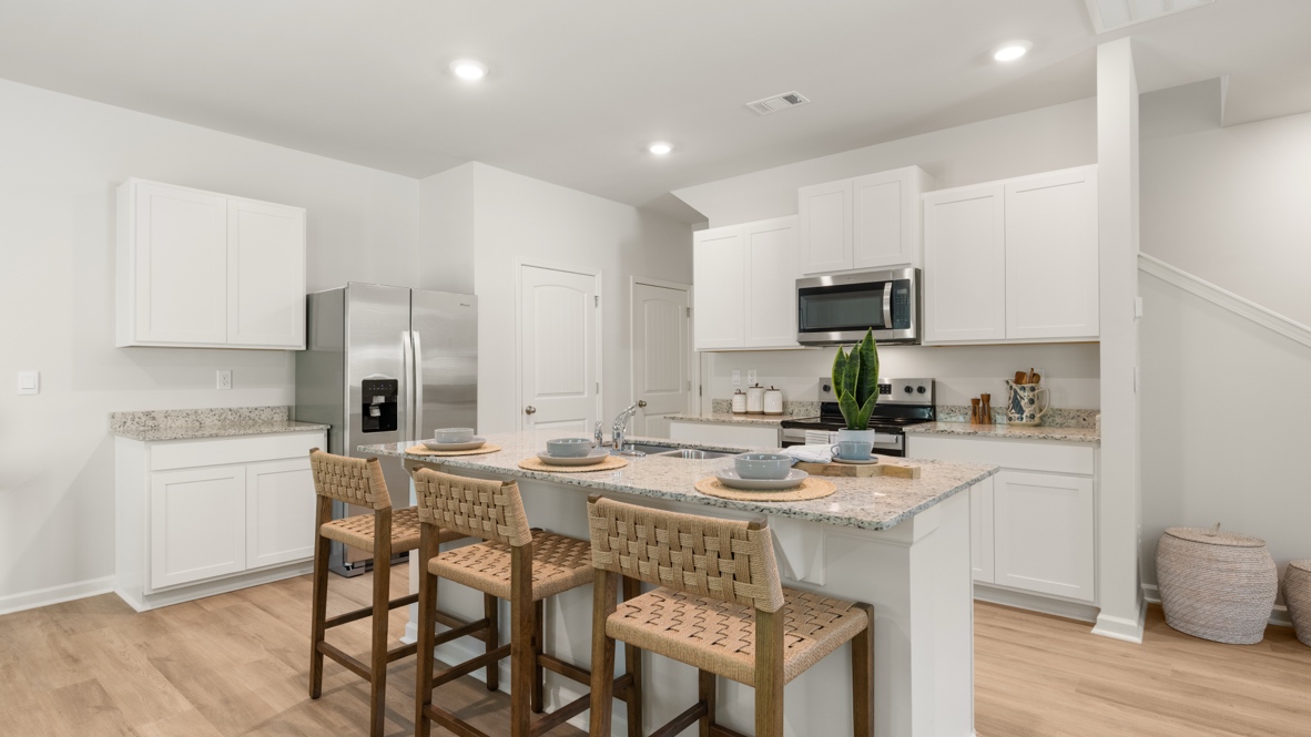 Interior kitchen with center island and white cabinets