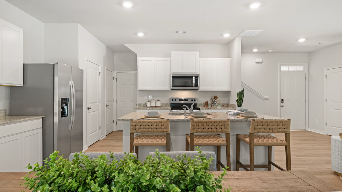 Interior kitchen with center island and white cabinets