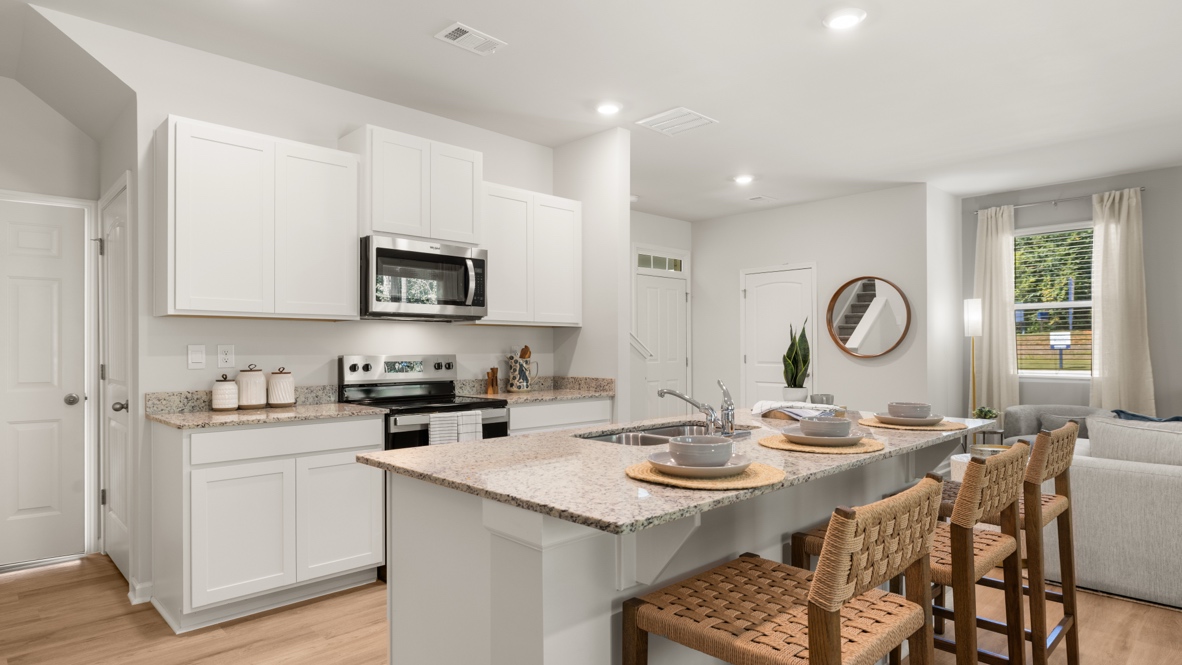 Interior kitchen with center island and white cabinets