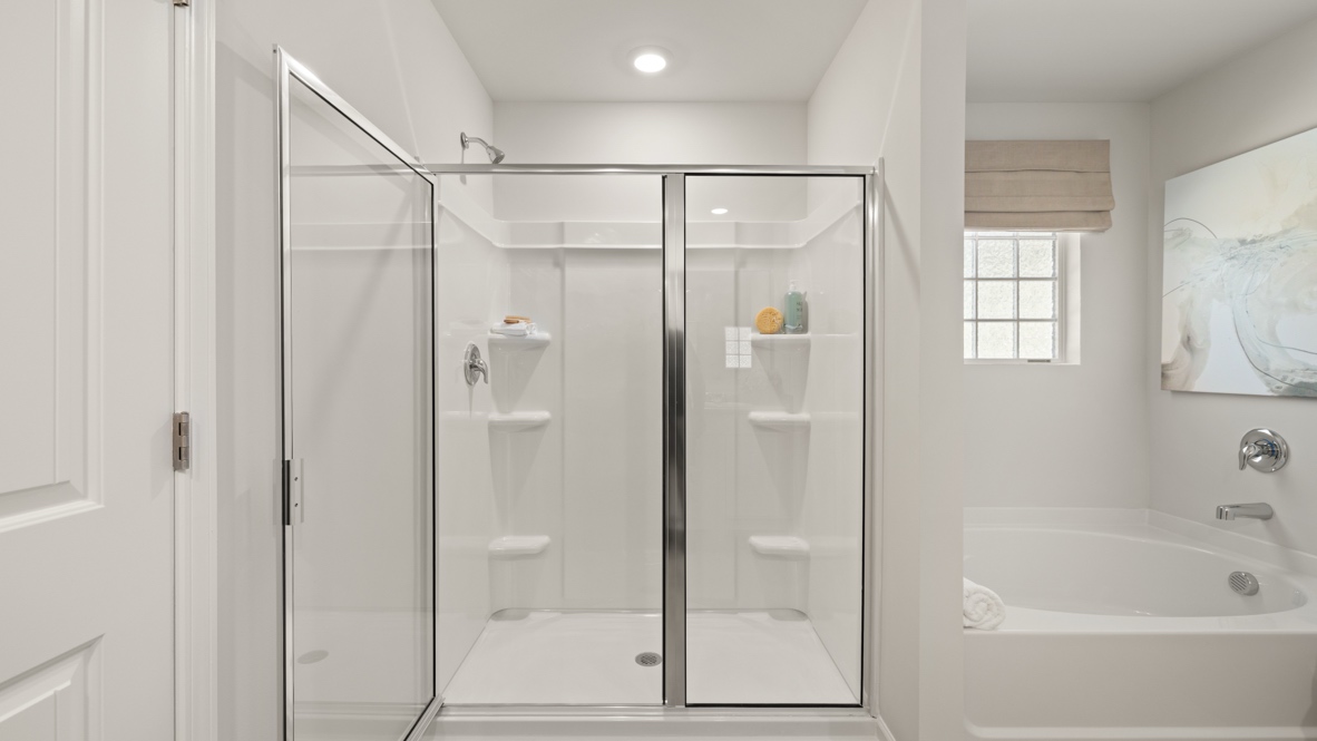 Interior primary bathroom with shower and bath tub
