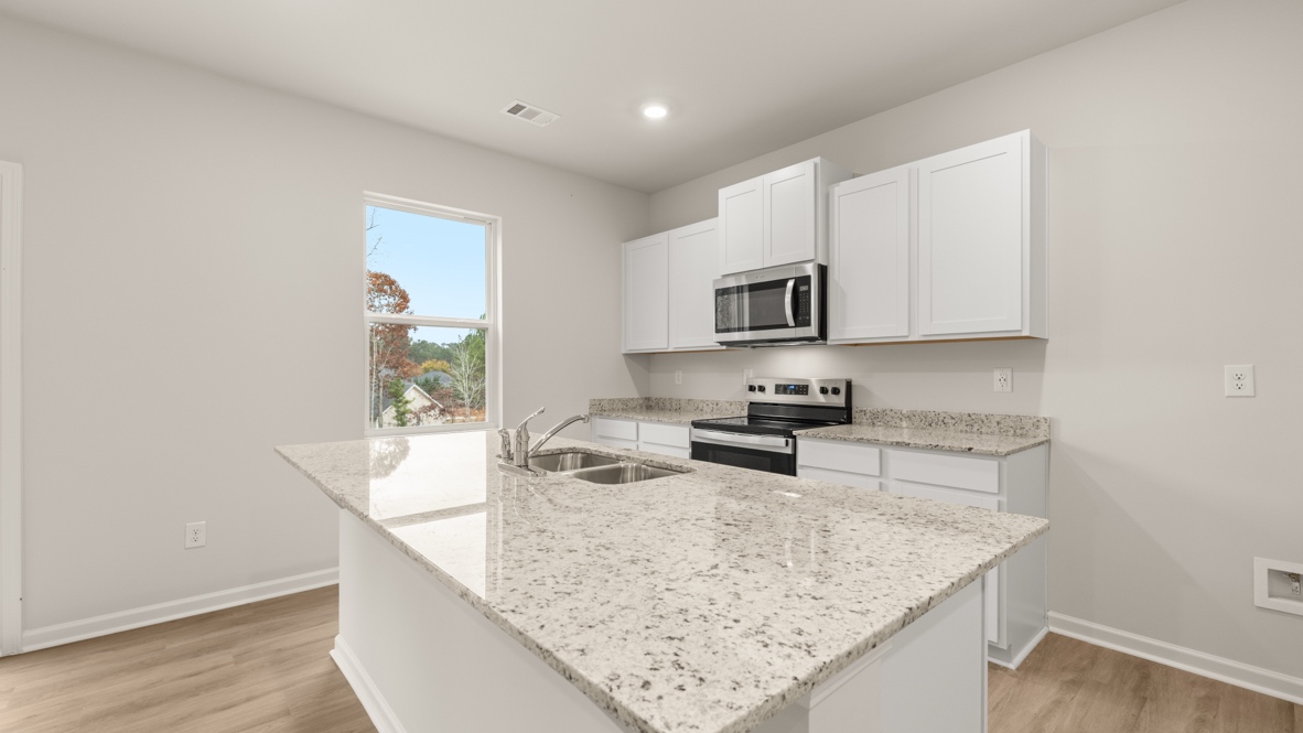 Interior kitchen with center island and white cabinets