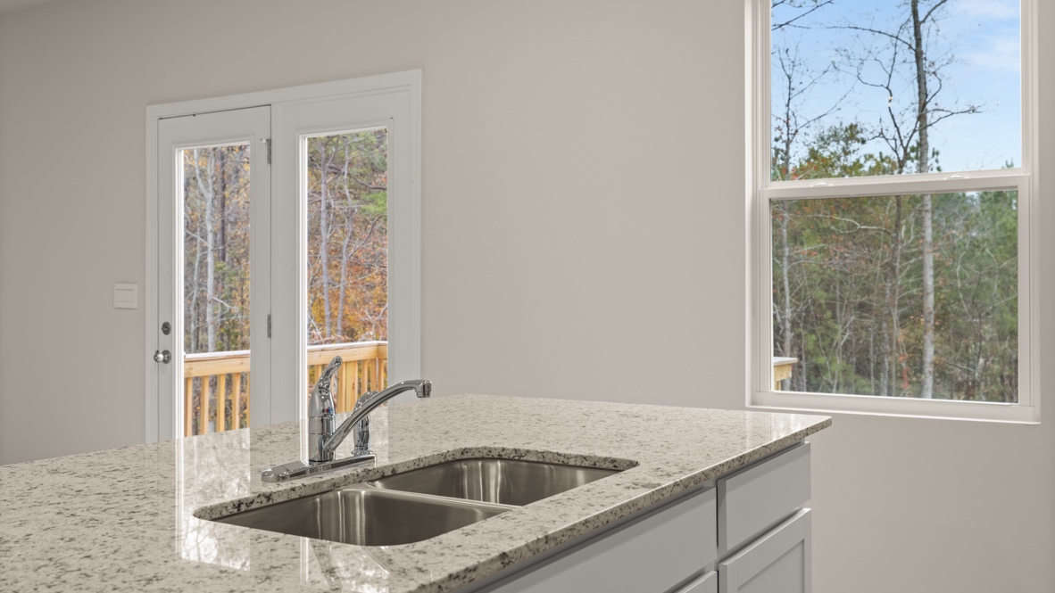 Interior kitchen with center island and white cabinets
