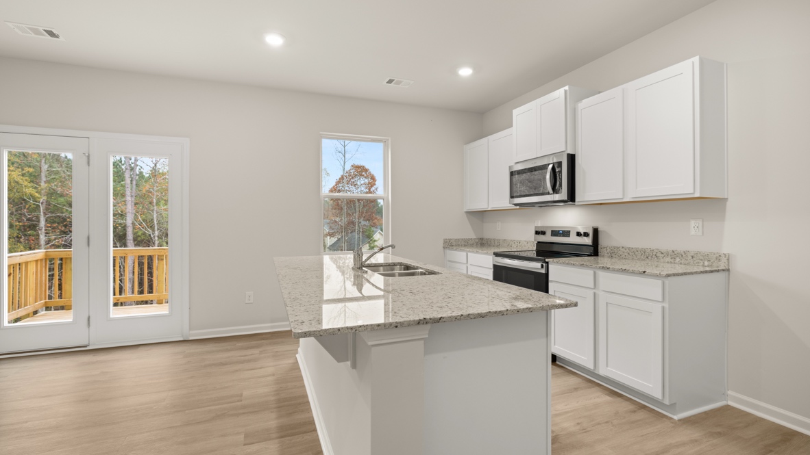 Interior kitchen with center island and white cabinets