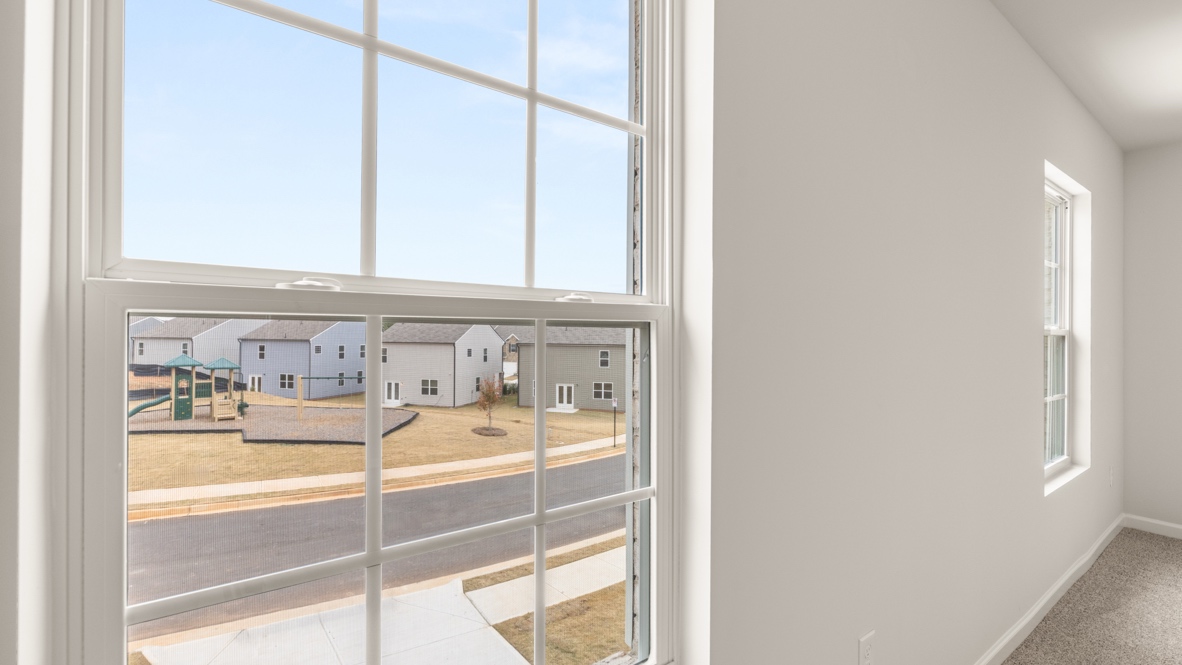 Interior primary bedroom with large windows