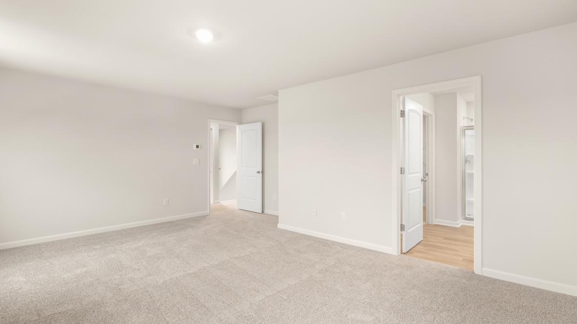 Interior primary bedroom with large windows