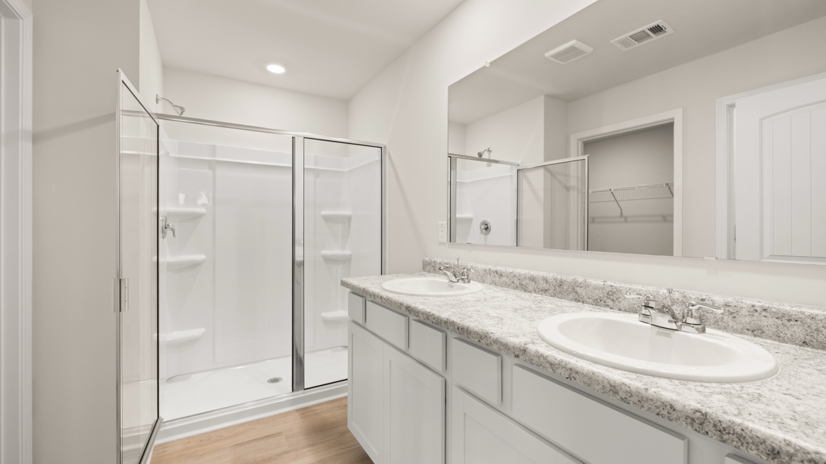 Interior primary bathroom with double sink and shower