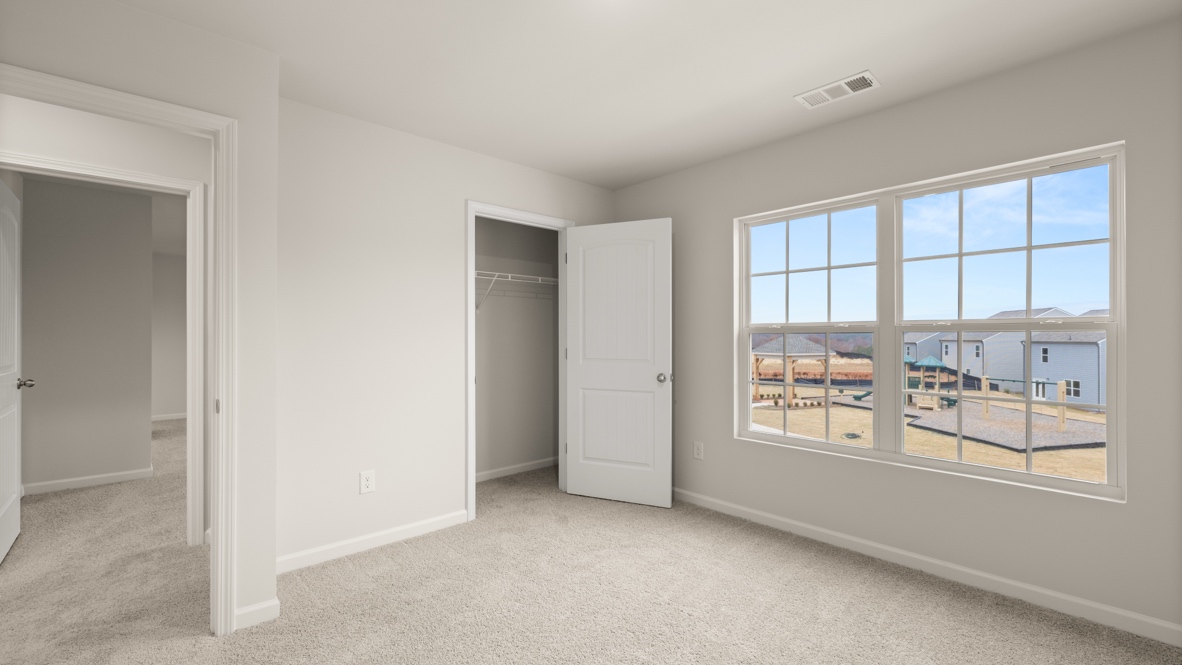Interior bedroom with large windows and closet