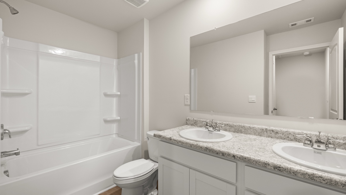 Interior bathroom with double sink and full-sized shower