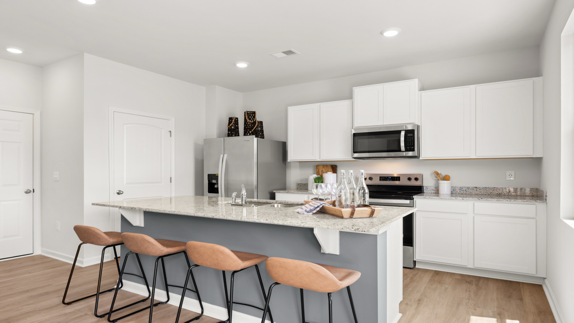 Interior kitchen with center island and white cabinets