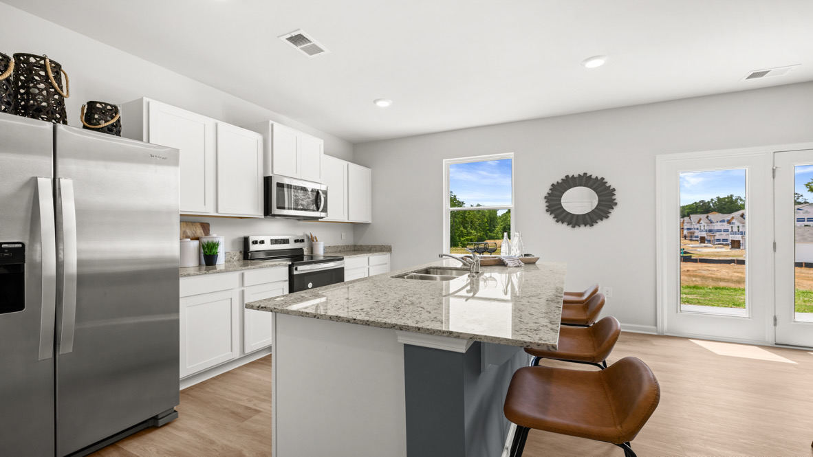 Interior kitchen with center island and white cabinets