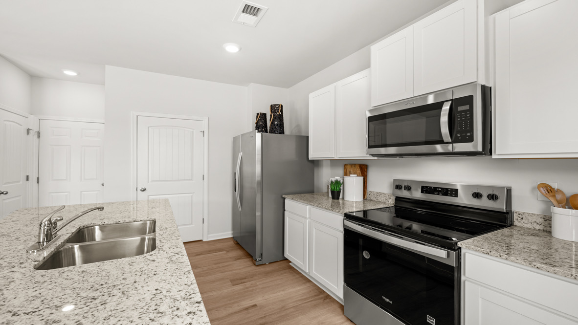 Interior kitchen with center island and white cabinets