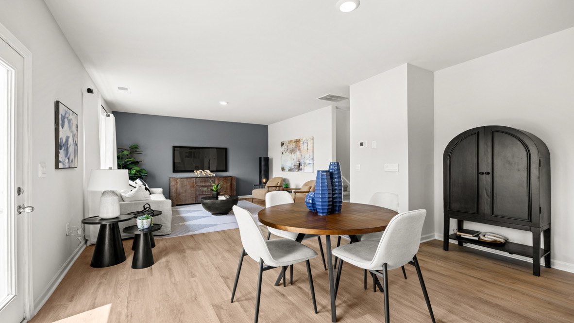 Interior dining area open to living area with accent wall