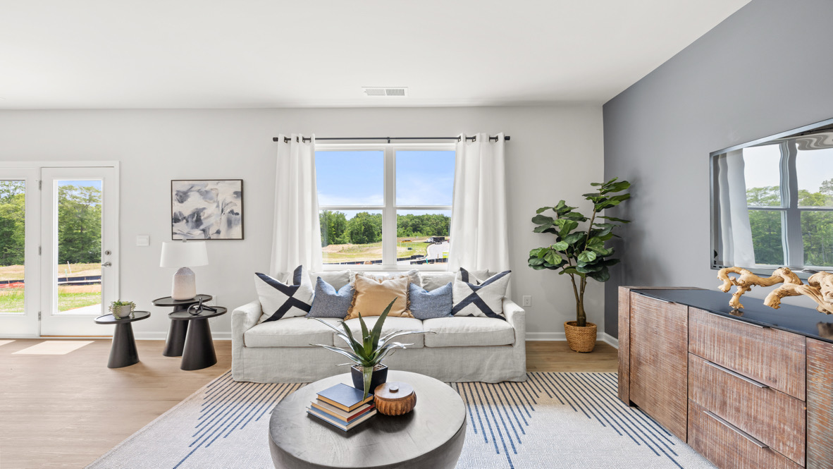 Interior living area with accent wall and large windows