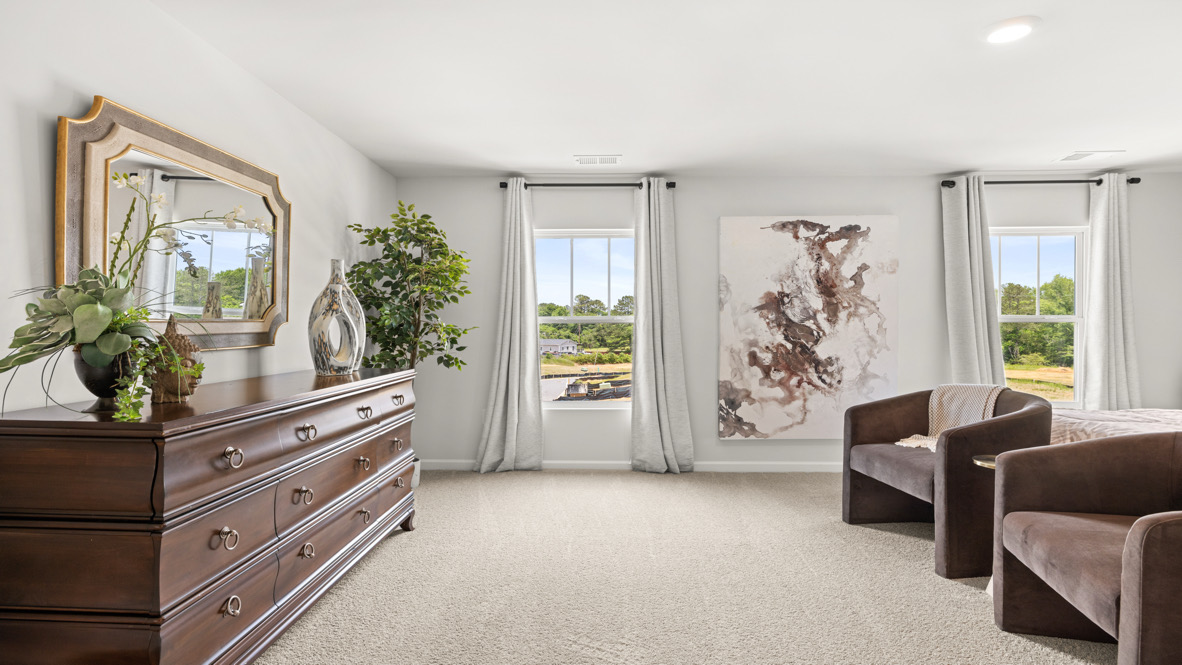Interior primary bedroom with large windows and accent wall