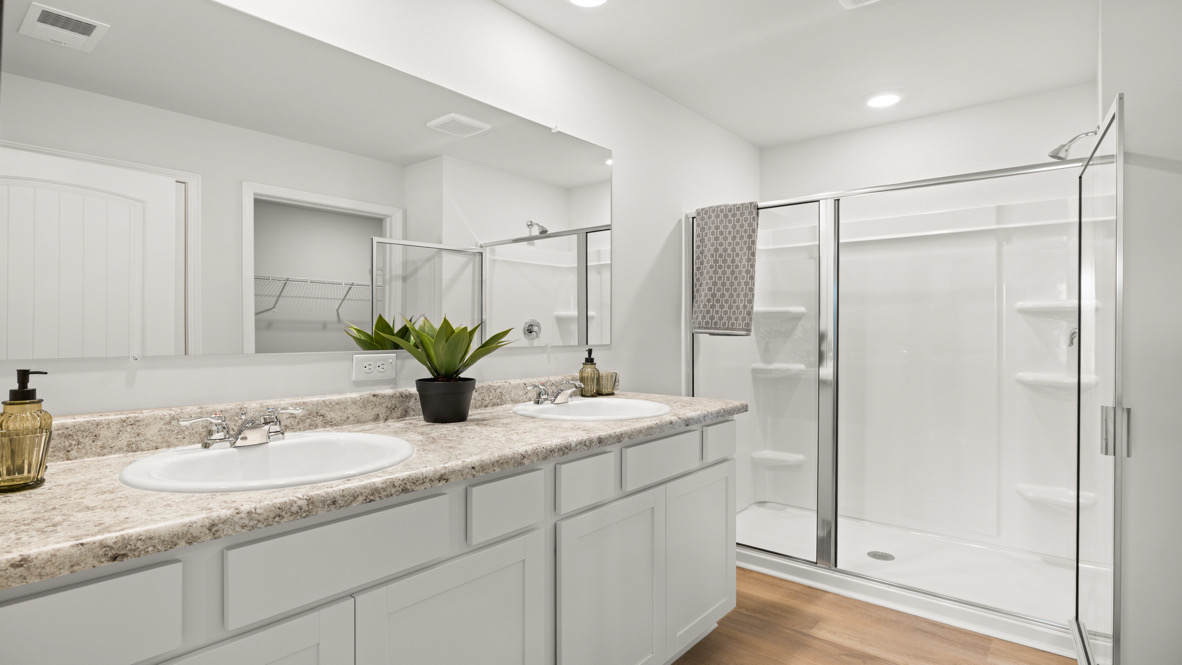 Interior primary bathroom with double sink and shower