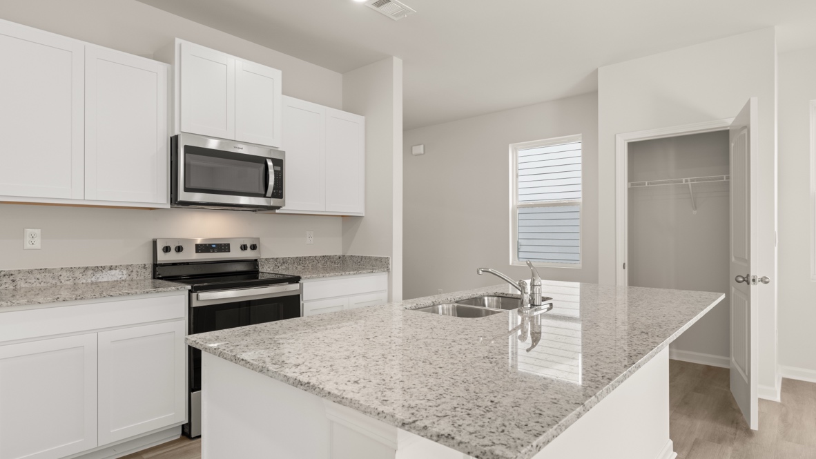 Interior kitchen with center isladn and white cabinets