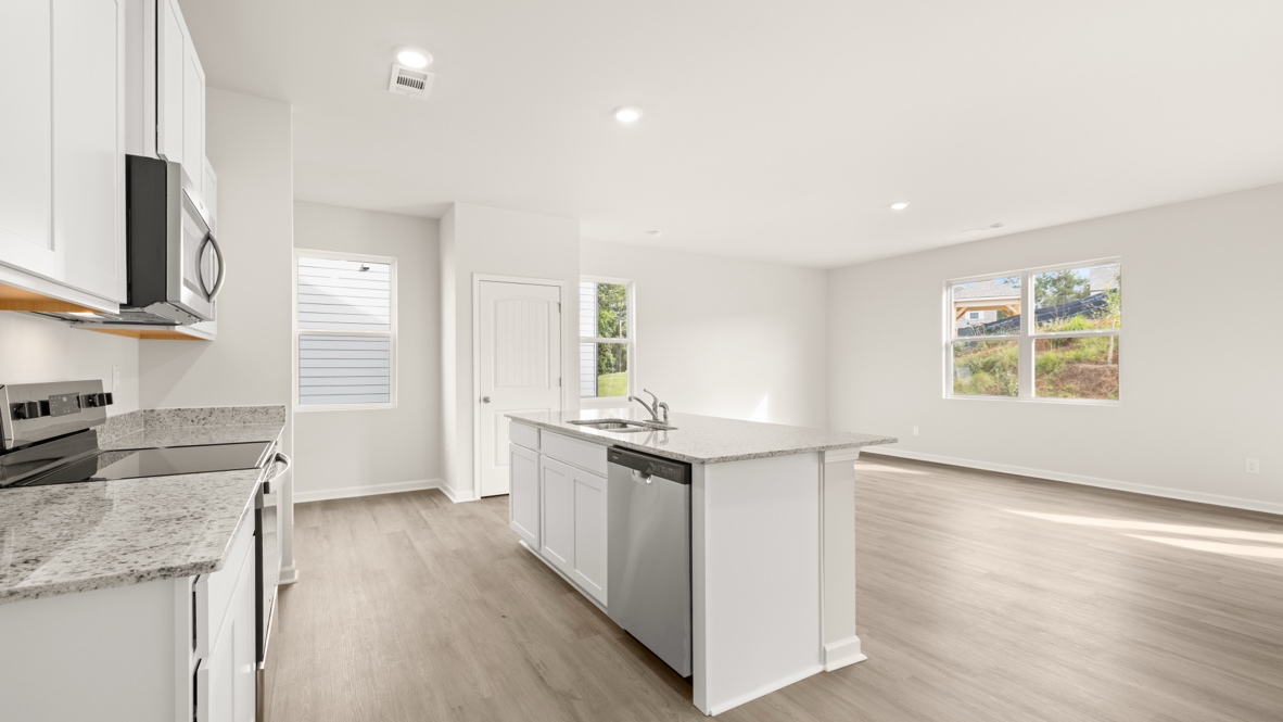 Interior kitchen with center isladn and white cabinets