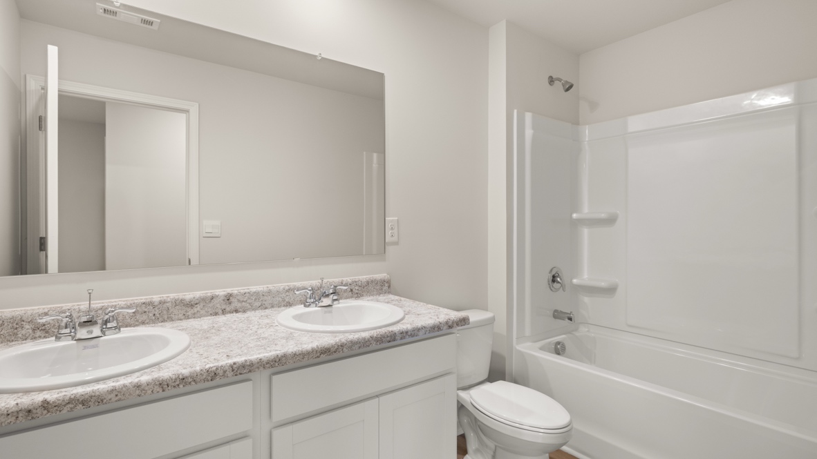 Interior bathroom with double sink and full-sized shower